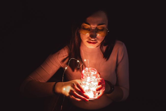 Woman in sunglasses with lamp