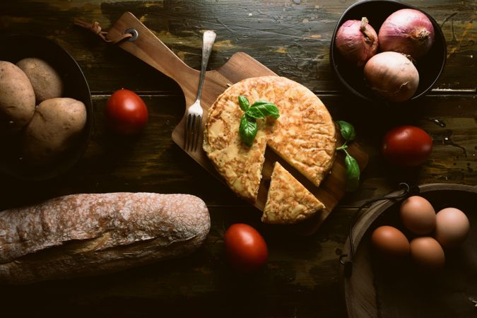 Cooking ingredients around pie on table