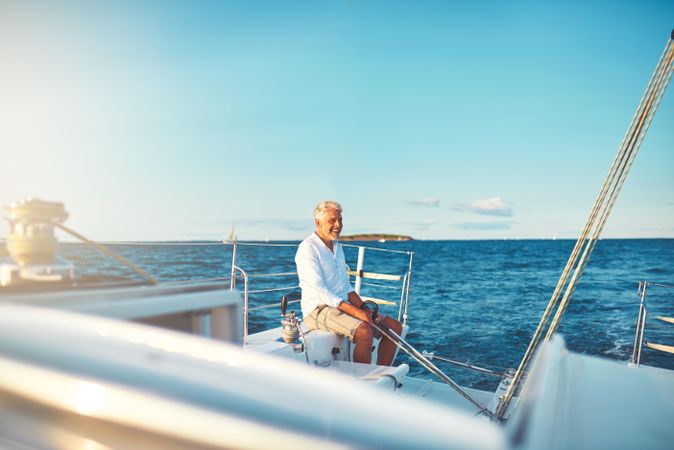 Man sitting and relaxing on sailing yacht on clear day