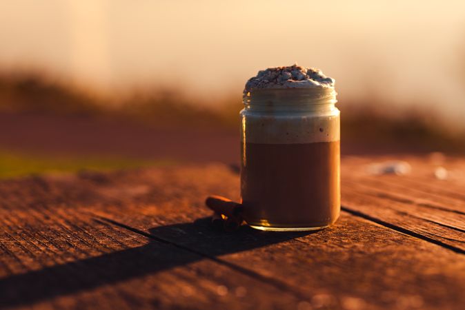 Cinnamon near coffee on table