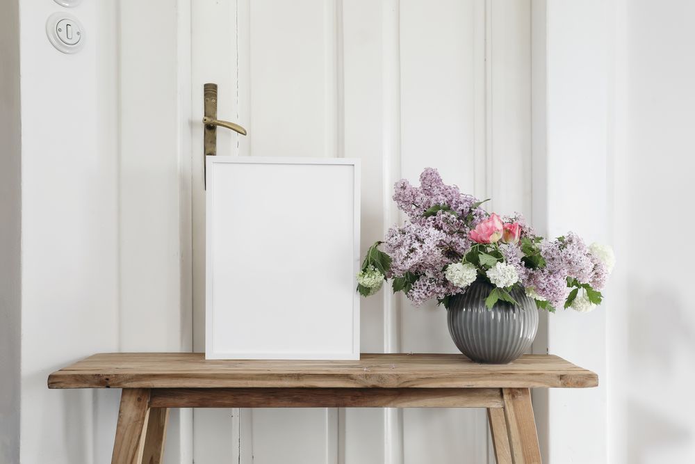 Vintage spring floral still life with blank picture frame mockup on old wooden bench