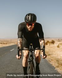 Professional athlete cycling on highway 5qkpzq