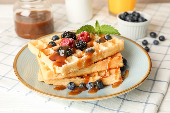 Composition of breakfast with belgian waffles, space for text