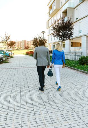Businessman and businesswoman walking to their office