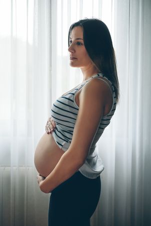 Pregnant holding her belly