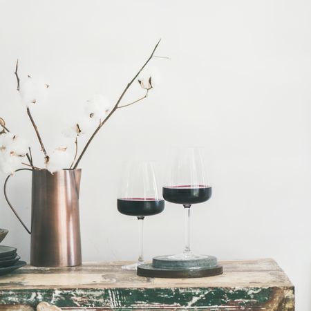 Wine glasses with dried cotton in vase, square crop, copy space