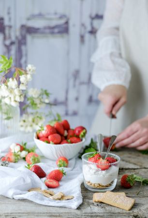 Confectioner cooking dessert of ripe strawberries