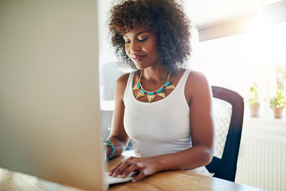 Businesswoman in bright office working in her home office in the morning