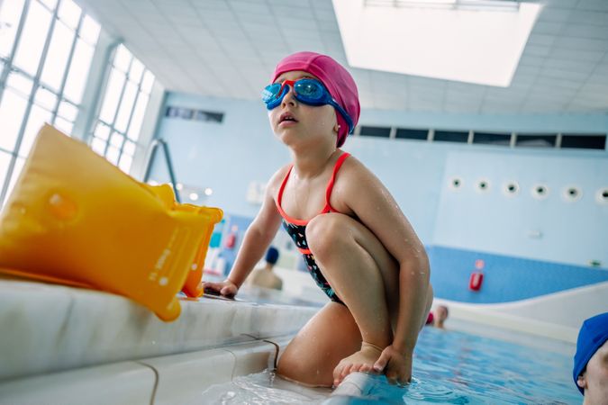 Girl coming out from swimming pool