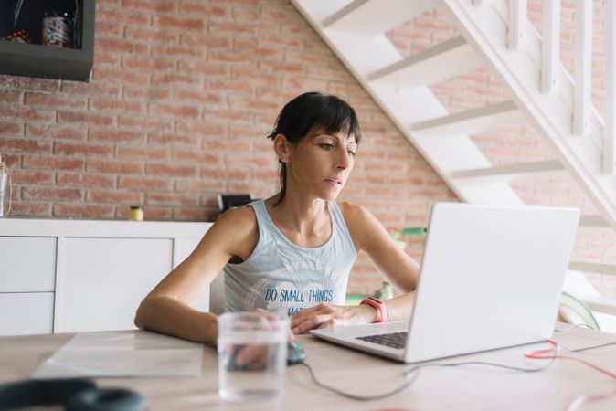Woman working at laptop in modern loft