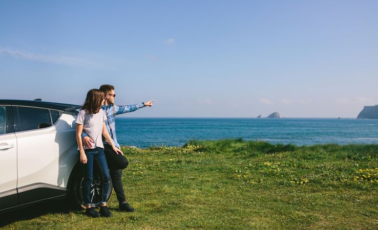 Couple with car watching landscape