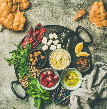 Top view of tray with bowls of Mediterranean, Middle Eastern foods