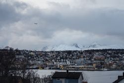 Wonderful cityscape against snowy highland in cold overcast weather