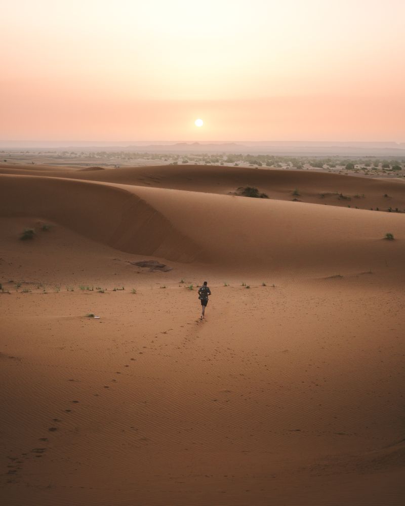 man in summer shirt walking in desert