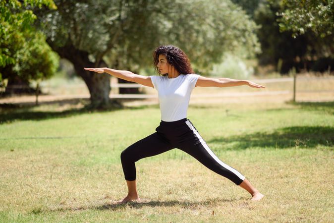 Arab woman doing yoga pose in nature