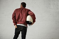 Rearshot of man in dark red jacket with hand in back pocket