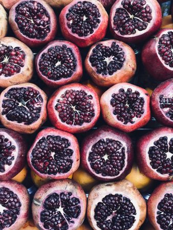 Cut pomegranates in rows at outdoor market