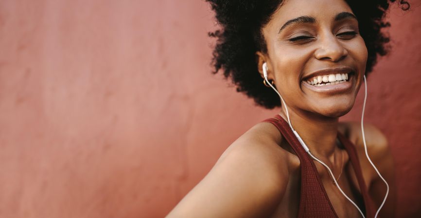 Female laughing and listening to music