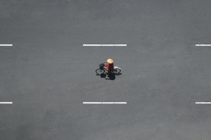 Aerial view of person riding bicycle on empty road