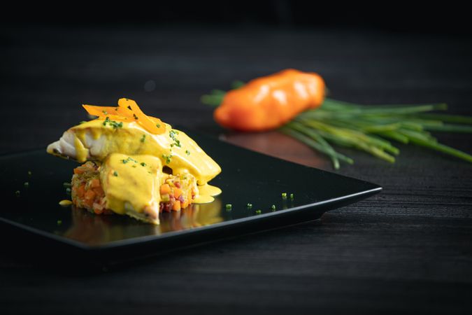 Corvina with yellow pepper sauce in plate