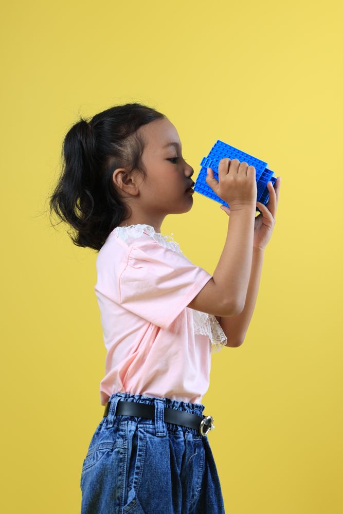 Asian Girl Kids Drink Water from Blue Cute Cup