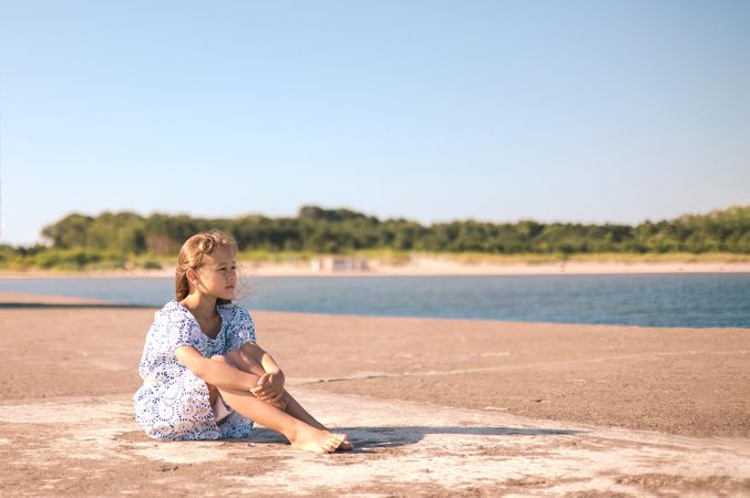 Little girl in a dress on the beach