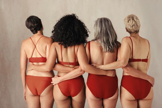 Shot of four anonymous women of all ages embracing their natural bodies