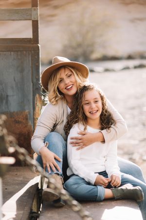 Mother hugging girl in truck body
