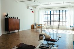 Room with floor to ceiling window with bright walls and vintage furniture