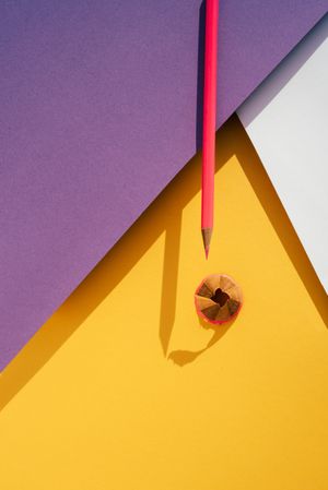 Back to school: Pink pencil on geometric background