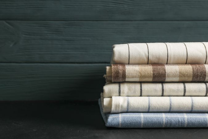 Stack of fabric napkins on table, space for text