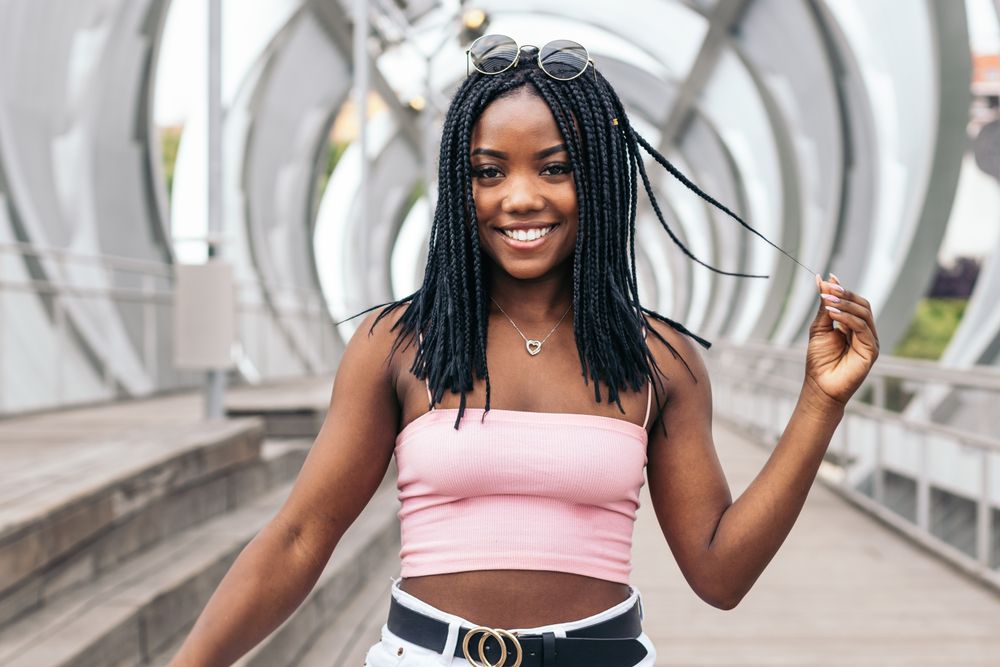 Portrait of a Black young woman enjoying the summer in the city