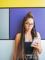 Woman with dreadlocks in glasses taking selfie