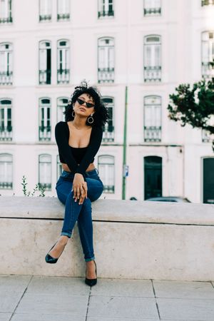 Fashionable Black female relaxing in city