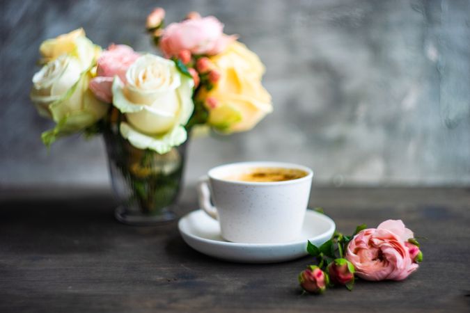 Side view of coffee with bouquet of flowers
