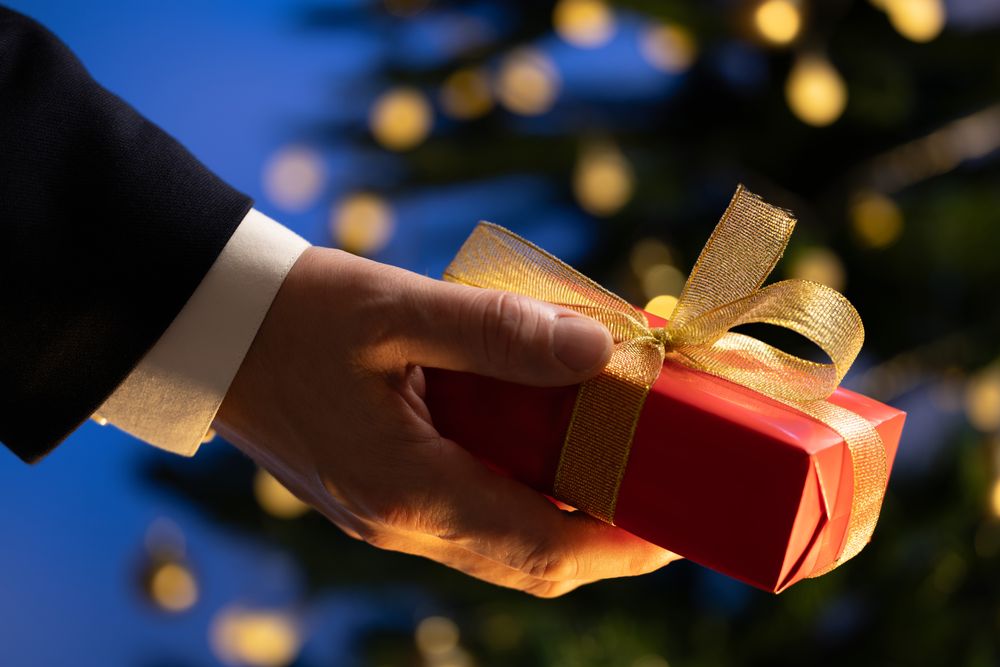 Businessman Holding Gift Christmas Tree