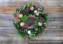Christmas holiday wreath with illuminated lights on rustic wooden planks bDdeAb