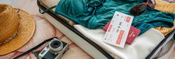 Open woman suitcase prepared for vacation