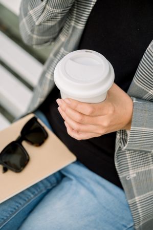 Crop woman with cup of coffee
