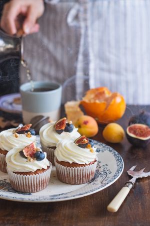 Carrot cupcakes with frosting, figs and blueberries