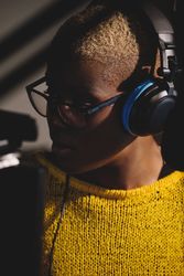 Focused Black female singer in headset