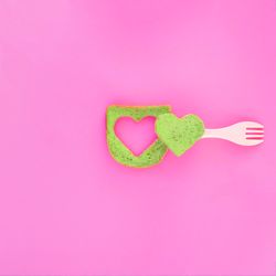 Green bread with heart piece cut in the center and plastic fork