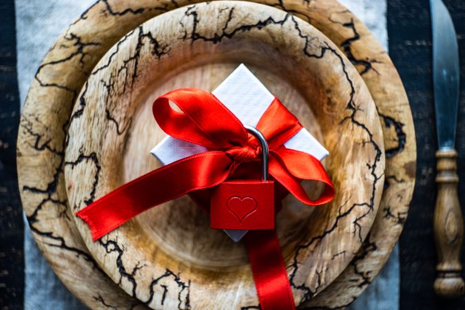Rustic plate with ribbon wrapped present with padlock