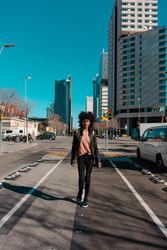 Woman with afro hair walking through the streets