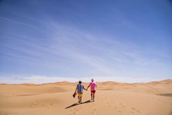 Anonymous gay couple walking in desert