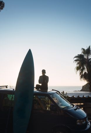 Man enjoying the sunrise in his camped van