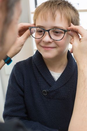 Young boy trying on glasses