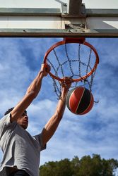 Latino basketball player throwing basketball ball
