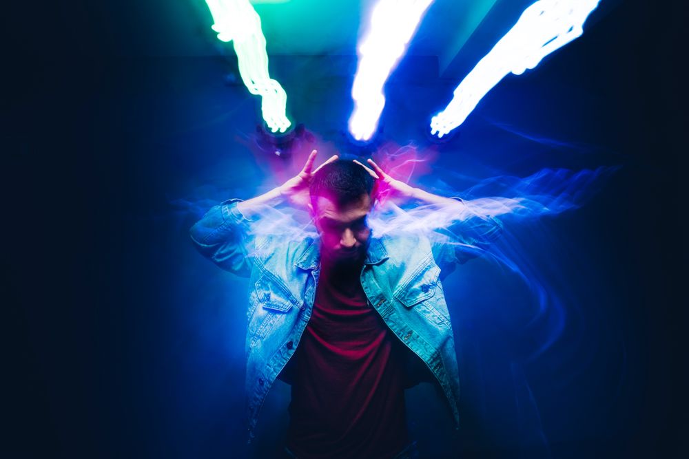 bearded man dancing in spotlight