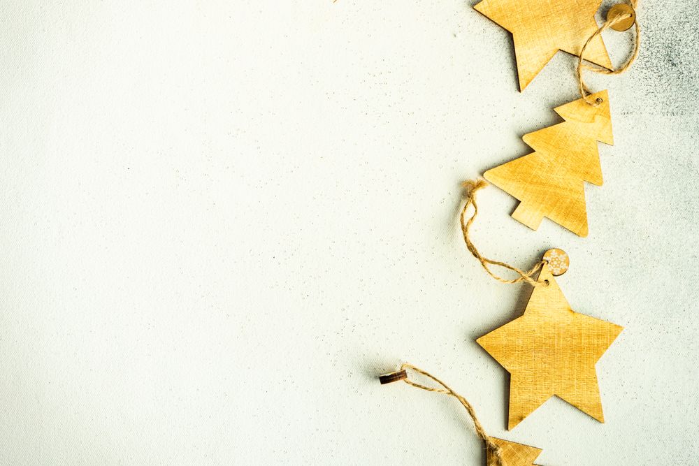 Tree and star Christmas ornaments on marble counter